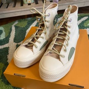 Cream/White platform high top converse with teal and purple details.